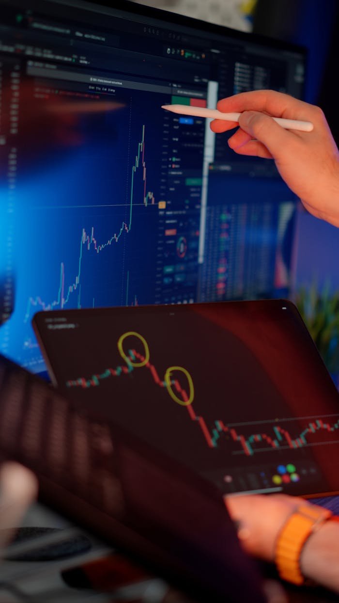 The Art of Drawing Readers In: Your attractive post title goes here A person analyzes cryptocurrency market trends on multiple screens with graphs.