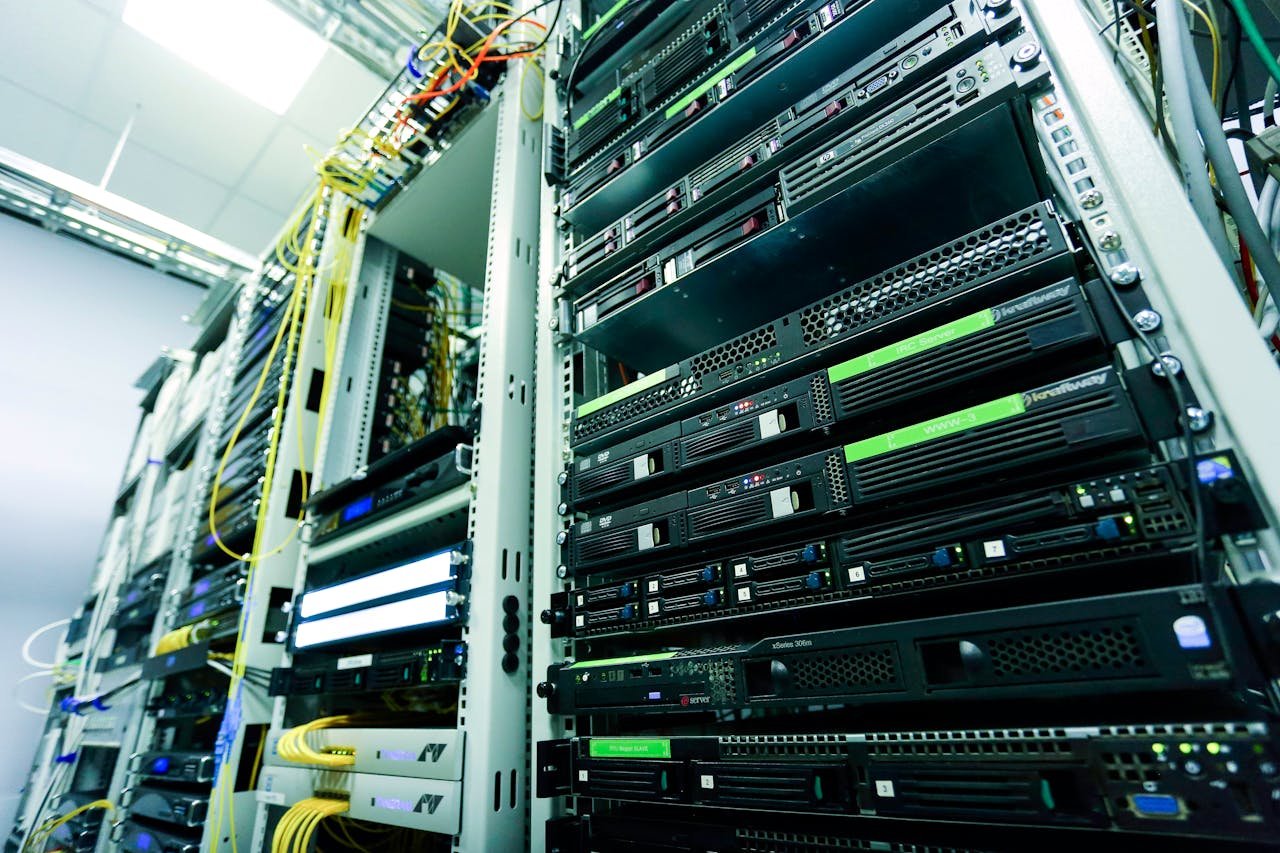 Home High-tech server rack in a secure data center with network cables and hardware components.