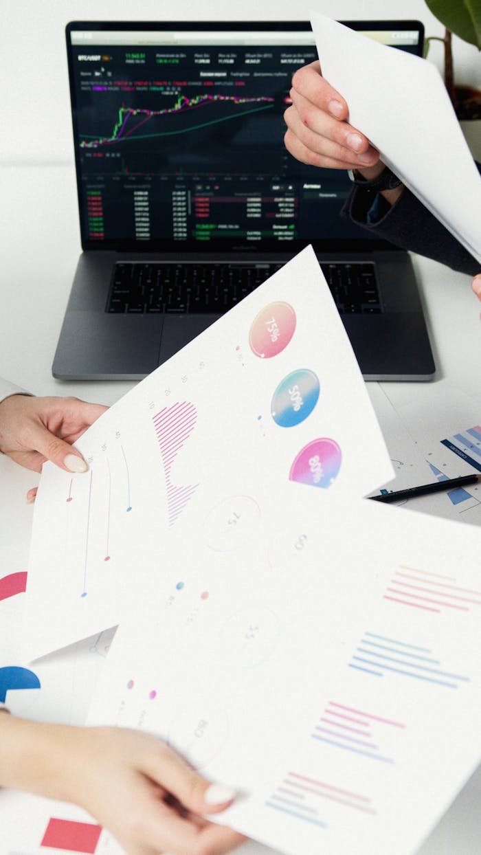 Home Business professionals reviewing data charts and graphs on laptop.