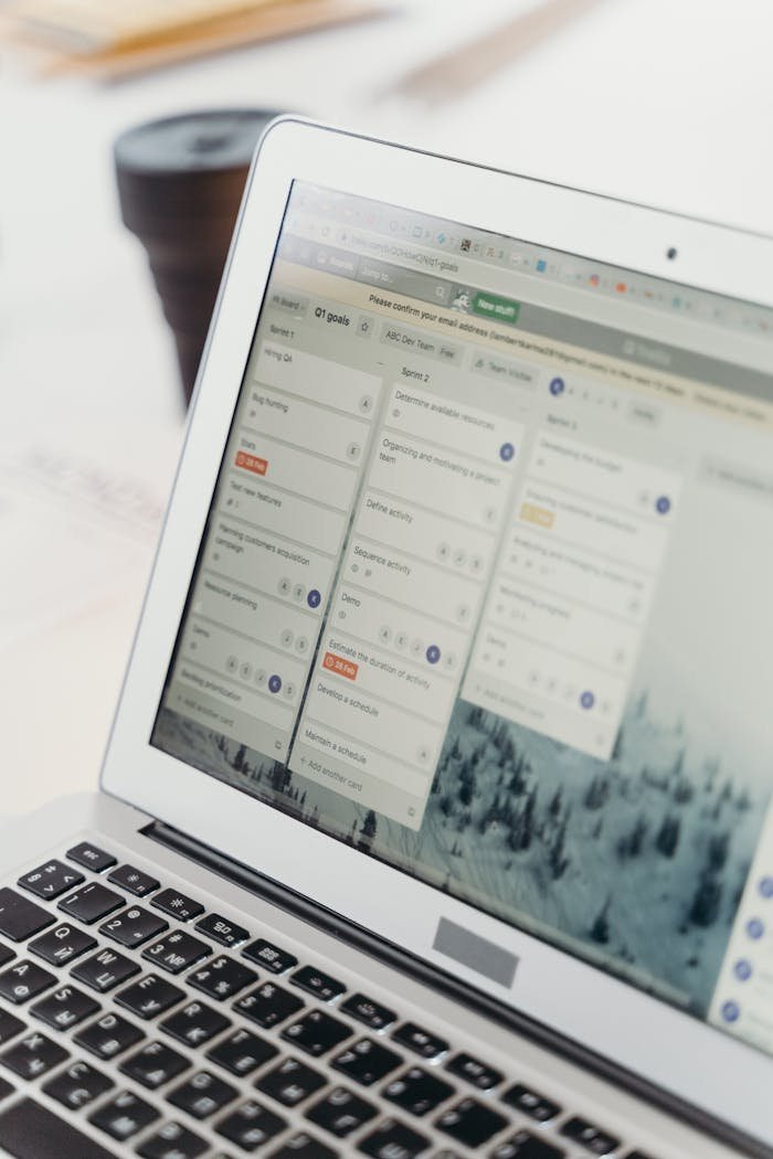 Home Close-up of a laptop screen showing project management software interface. Perfect for business or tech themes.